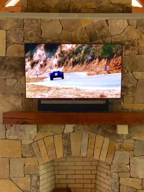 SONY TV and SONOS mounted on stone wall